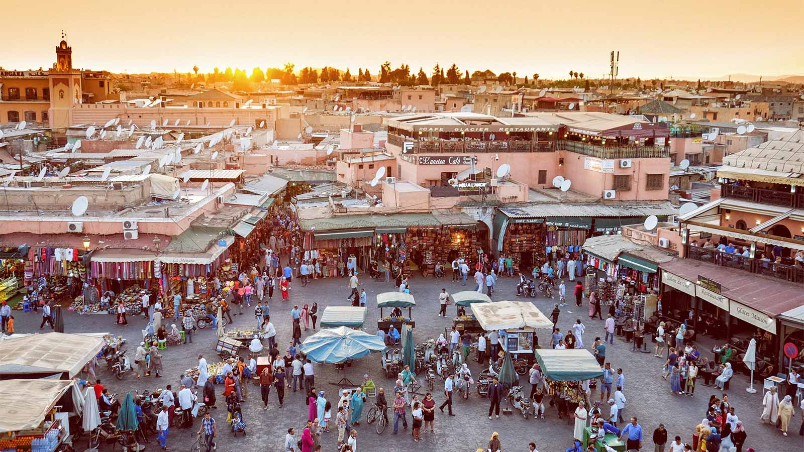 Crowds gathering at Jemaa el-Fna Square at sunset during the Medina Guided Walking Tour.
