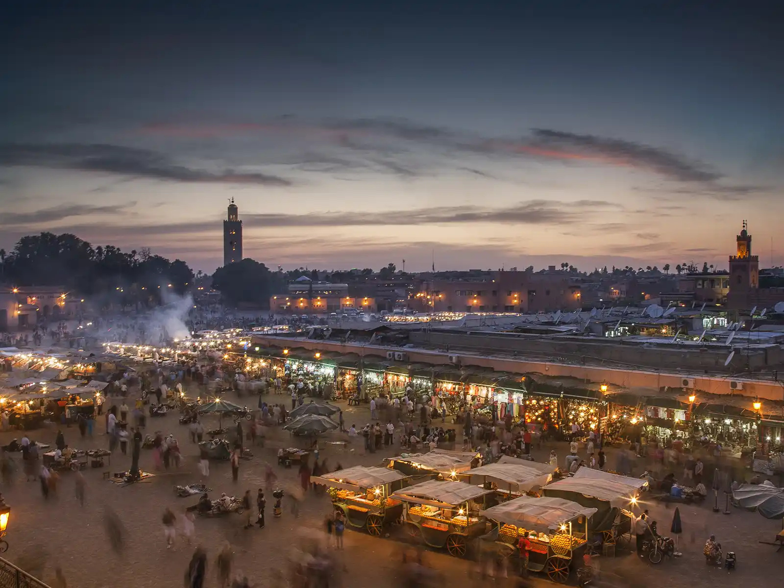 Jemaa el-Fna square and Koutoubia Mosque at dusk in Marrakech